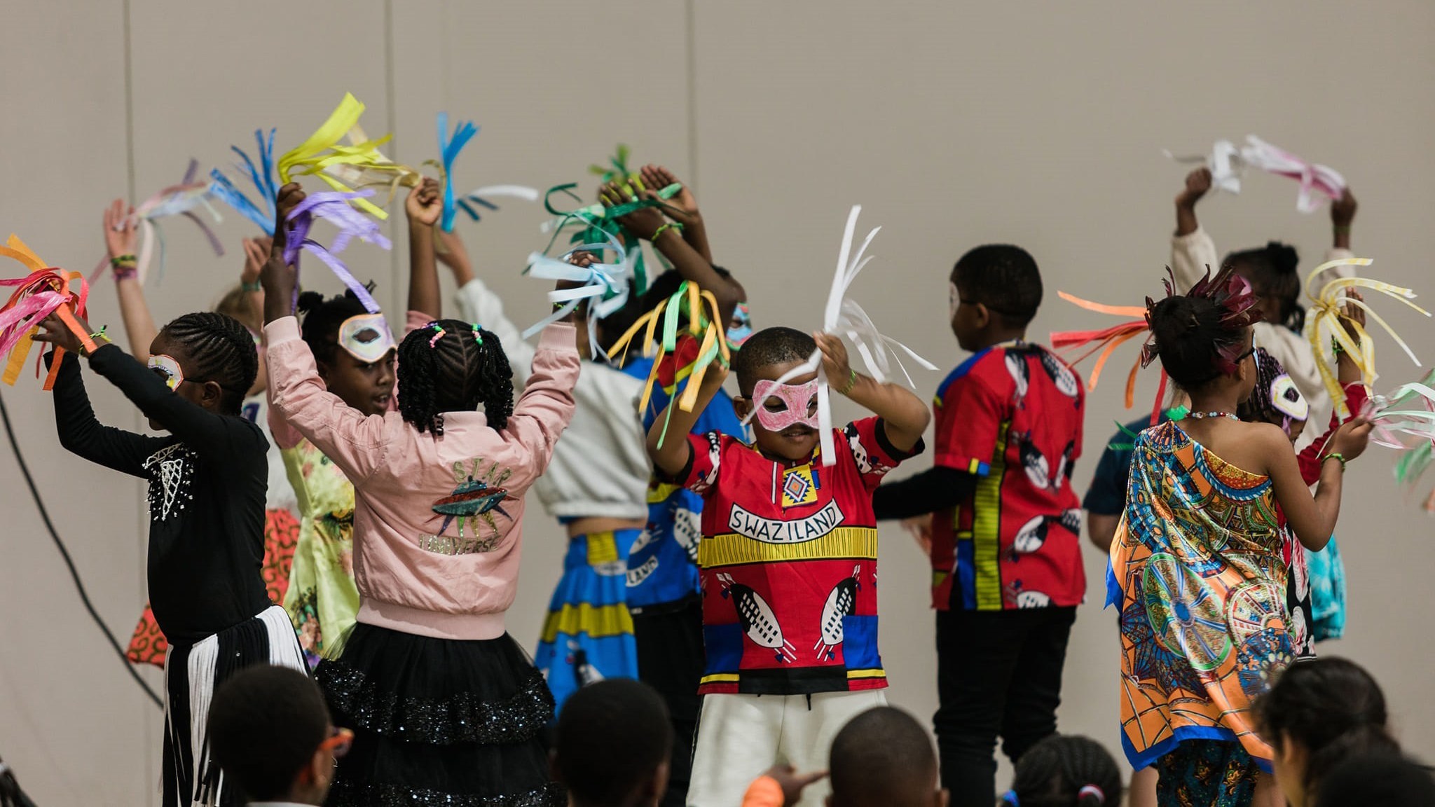 Celebrating diversity and culture! Montessori learners shine on stage, showcasing their vibrant heritage and performing with energy during a school cultural event.